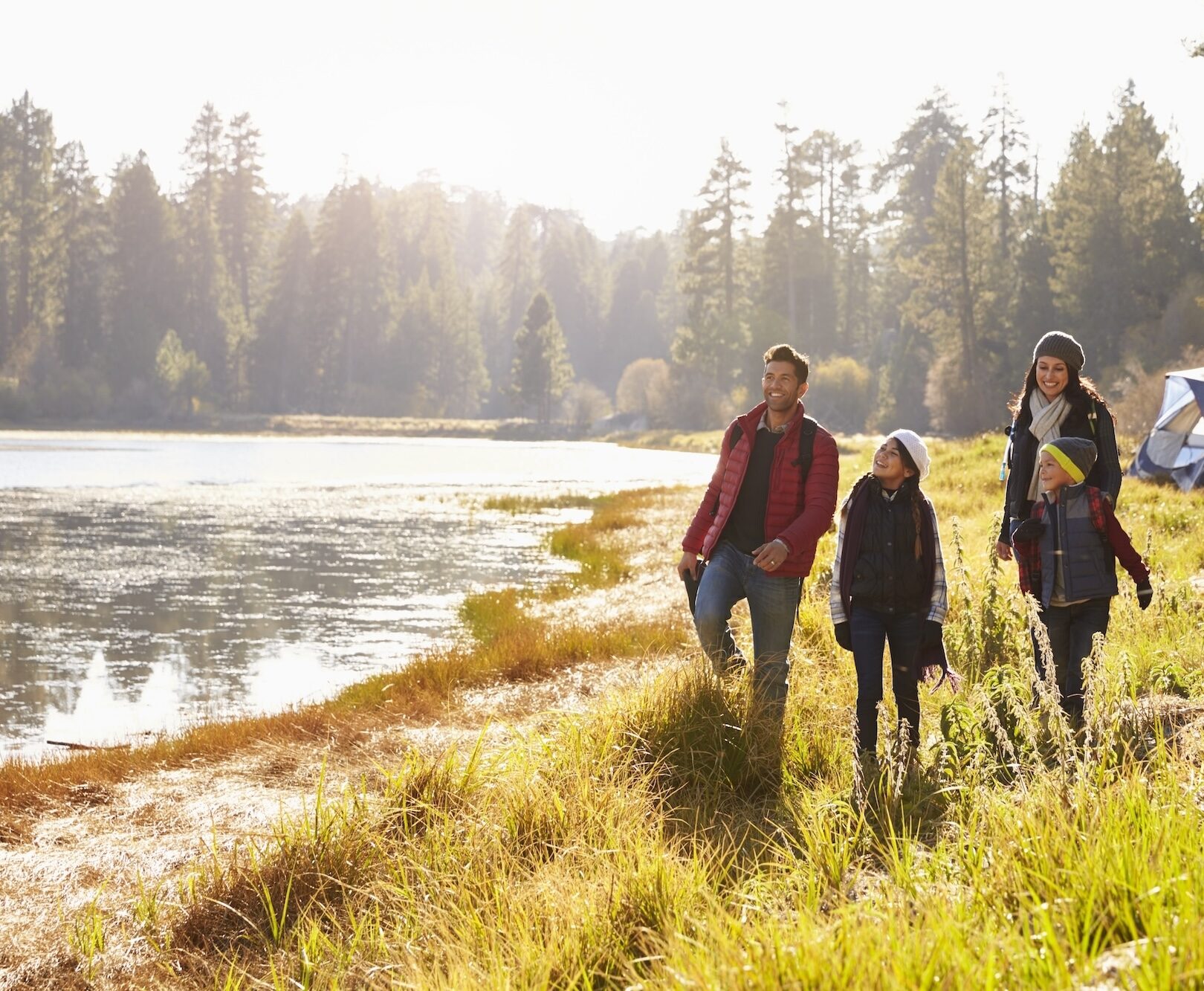 Parents and two children on camping trip walking near